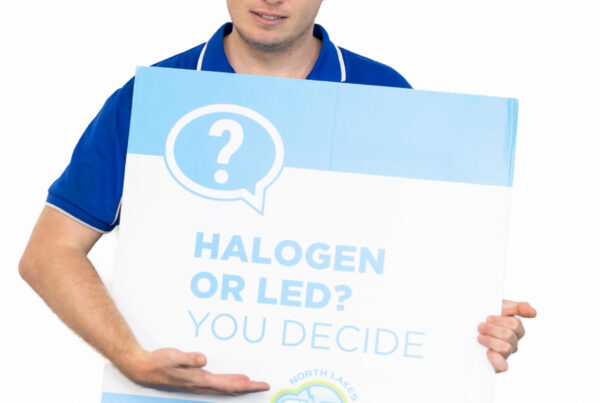 Stephen from lakes and surrounds electrical holding sign